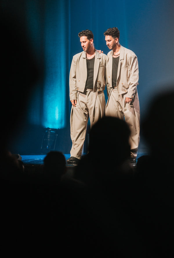 The French Twins in stage action with theatrical lighting.